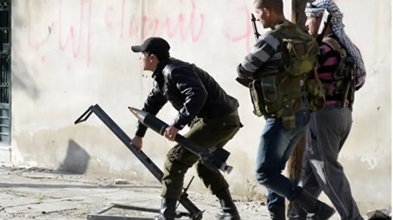 Rebel fighters prepare to launch a rocket