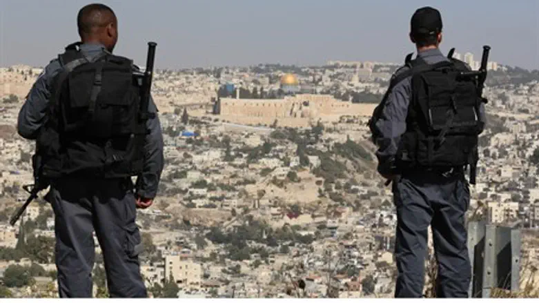 Illustration: Israeli border police stand ove