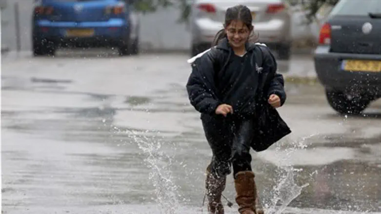 Girl plays in rain (illustrative)