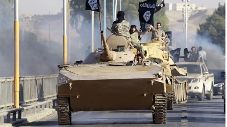 ISIS fighters parade captured tanks