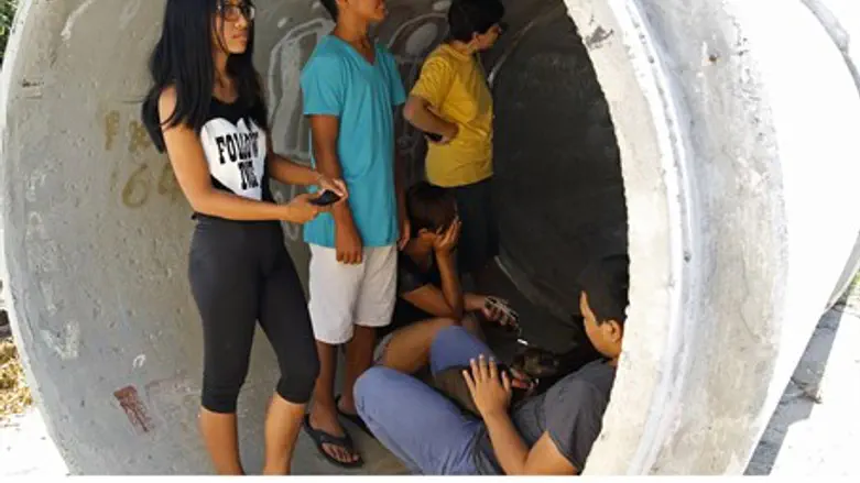 Taking cover from rocket fire (file)