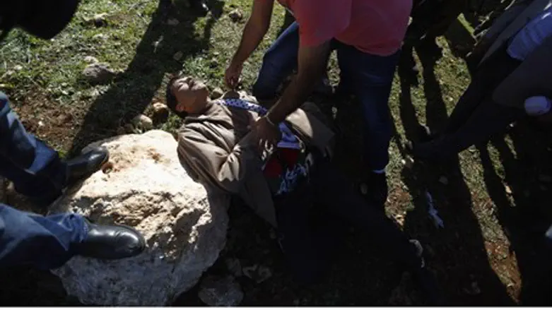 Ziad Abu Ein lies on the ground after clashing with IDF forces