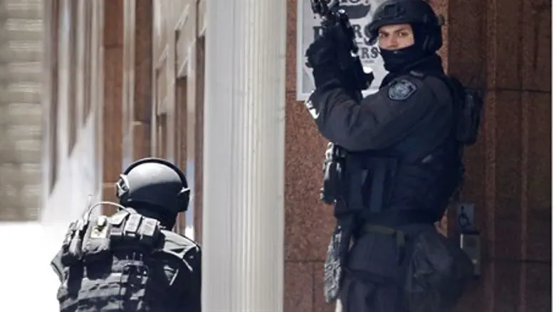 Police officers position themselves at a corner near Lindt cafe in Martin Place, where hos