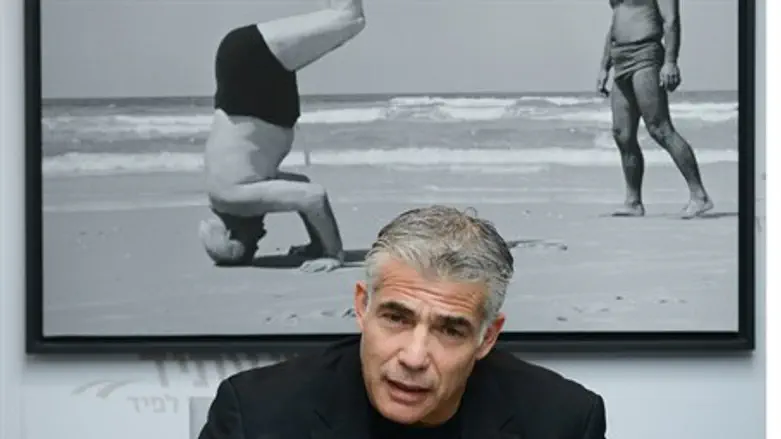 Yair Lapid with picture of David Ben-Gurion