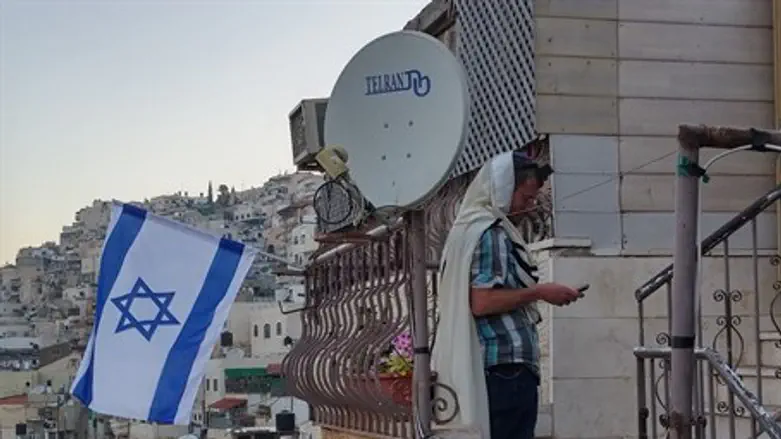 Jewish man prays outside his home in Shiloach