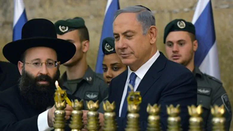 Netanyahu lights first Hanukkah candle with Border Police personnel