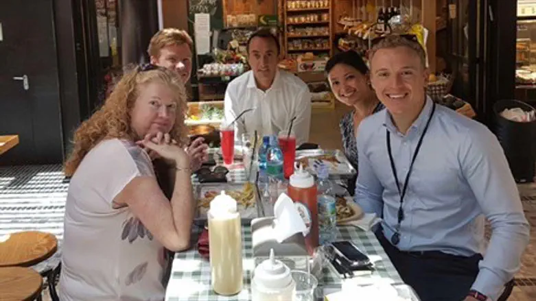 Australian Ambassador Dave Sharma (C) joins hosts embassy staff at Tel Aviv's Sarona Marke