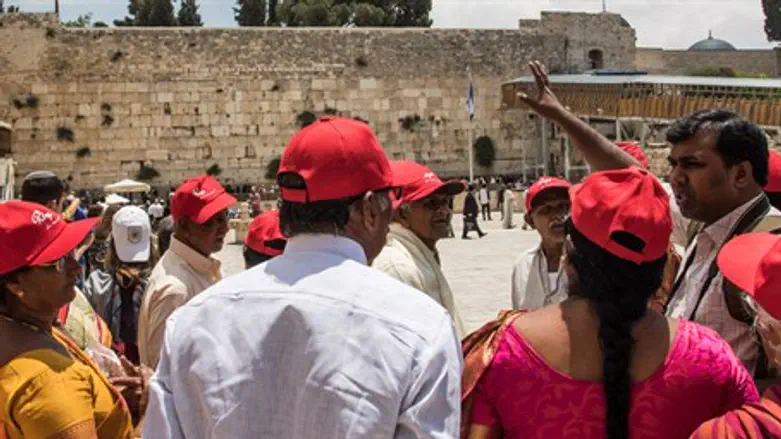 Tourists listen to guide near the Western Wall