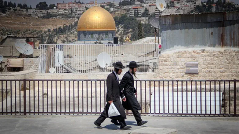 Haredi Jews walk close to the Temple Mount in Jerusalem