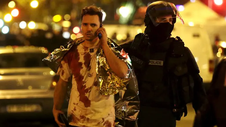 Police with victim outside Bataclan Theater in Paris