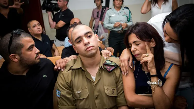 Elor Azariya sits with his family at his trial 