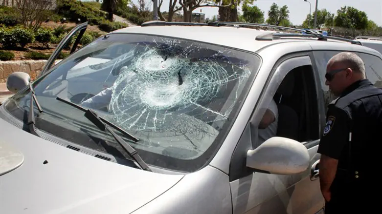 Car windshield smashed in rock attack (illustrative)