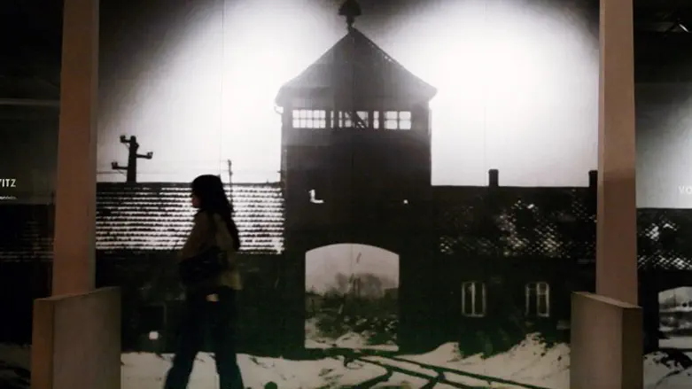Visitor walks past display at US Holocaust Memorial Museum