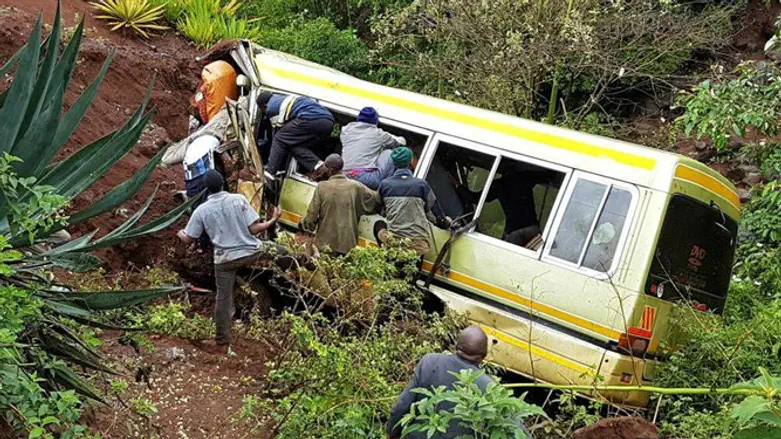 Rescue workers attempt to rescue victims of Tanzania bus crash.
