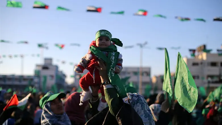 "Pain and destruction": Hamas mother holds baby aloft