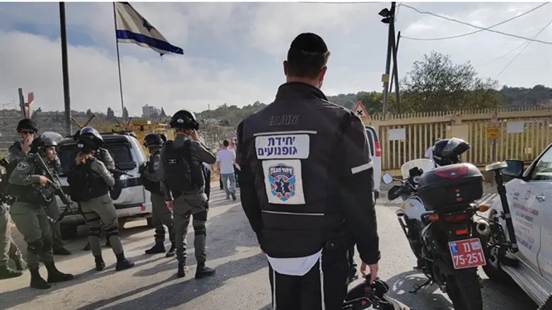 United Hatzalah ambucycle EMT stands near scene of terror attack in Har Adar