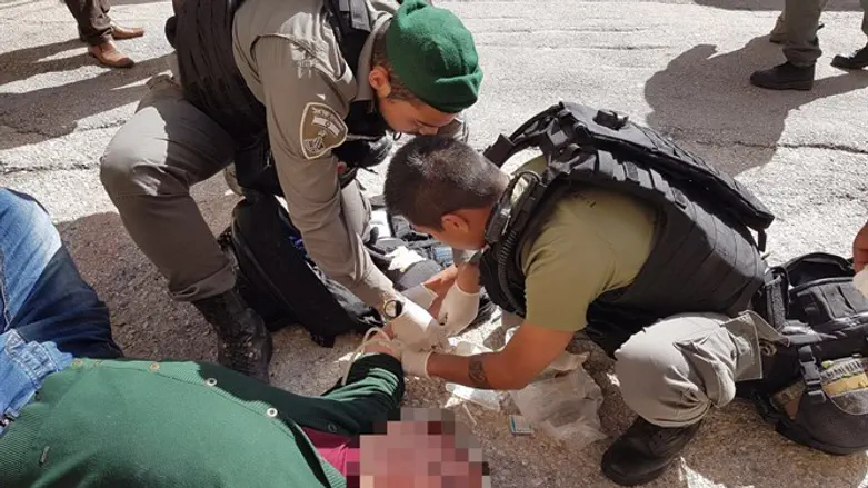 Border Police officers aiding an unconscious Palestinian Authority Arab
