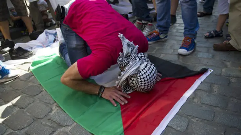 Pro-Palestinian protestor praying to Allah. France, July 2014.
