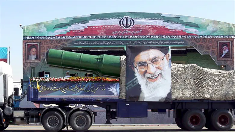 military truck carrying a missile and a picture of Iran's Supreme Leader Ayatoll