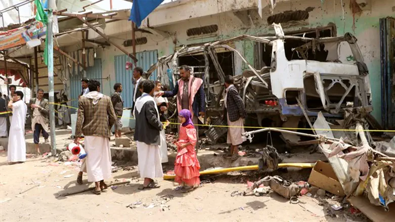 People view wreckage of school bus in Saudi Arabia's Saada province