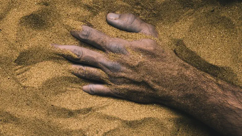 Injured man in sand