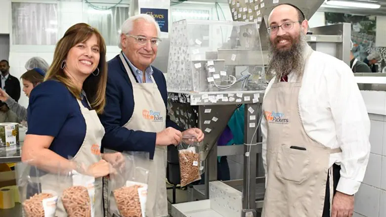 David Friedman and his wife pack food for needy