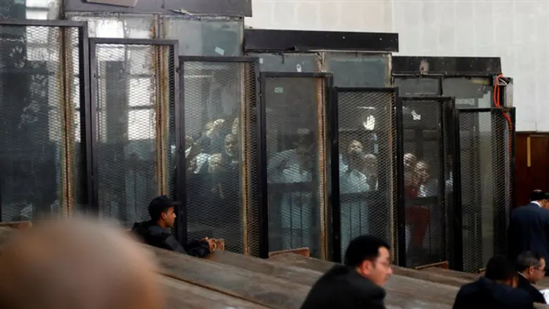 Muslim Brotherhood members behind bars during court session in Cairo