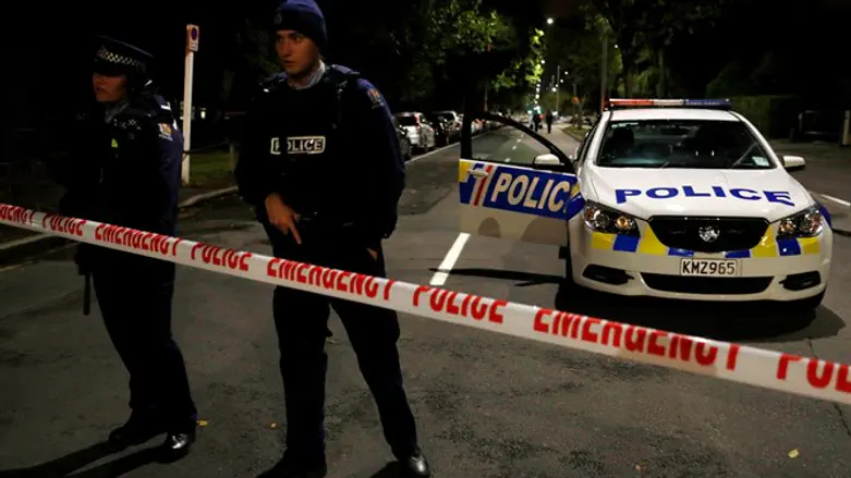 Armed police officers stand guard in outside mosque in Christchurch