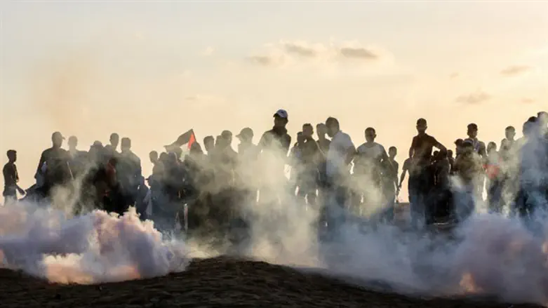 Arabs throw rocks during demonstration on Israel-Gaza border