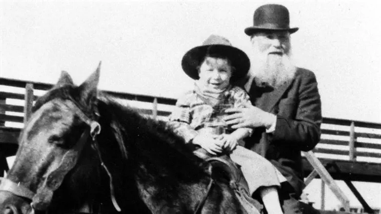 Robert Lazar Miller on horseback and his grandson at the Denver Stockyards, 1932