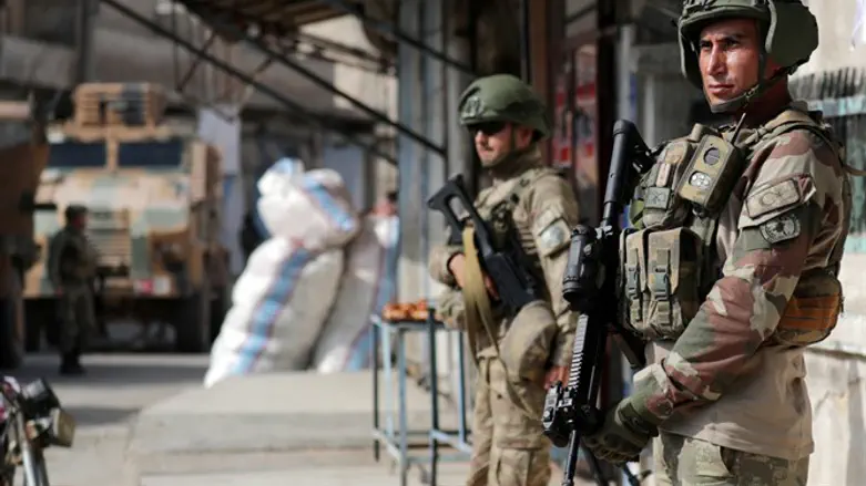 Turkish soldiers stand guard in Syria