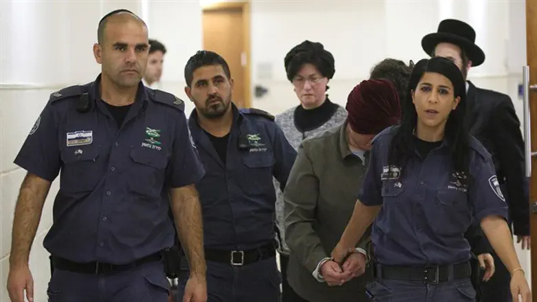 Malka Leifer led by prison service officers in Jerusalem court