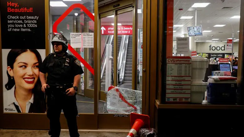 Police officer stands outside CVS store in NYC New York after the store was