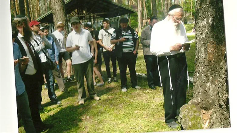 Rabbi Mendelevich leading group of Jewish youth in prayer in forest in Kiev